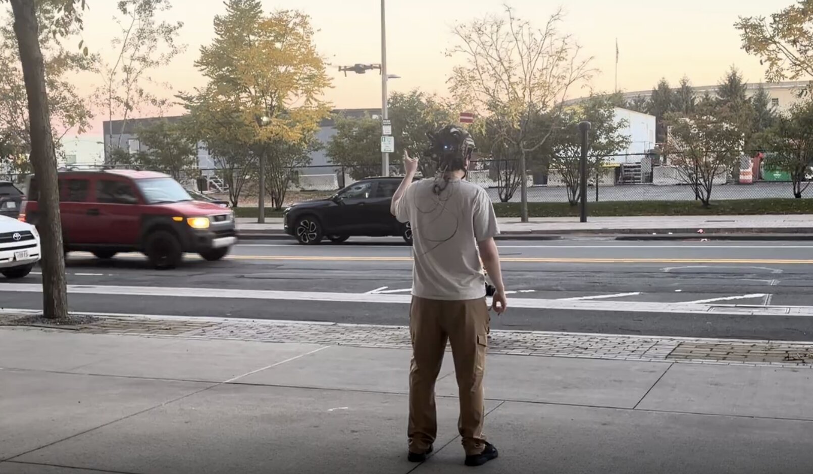 Field test: the wearer turns toward the drone overhead as the headband cues its direction