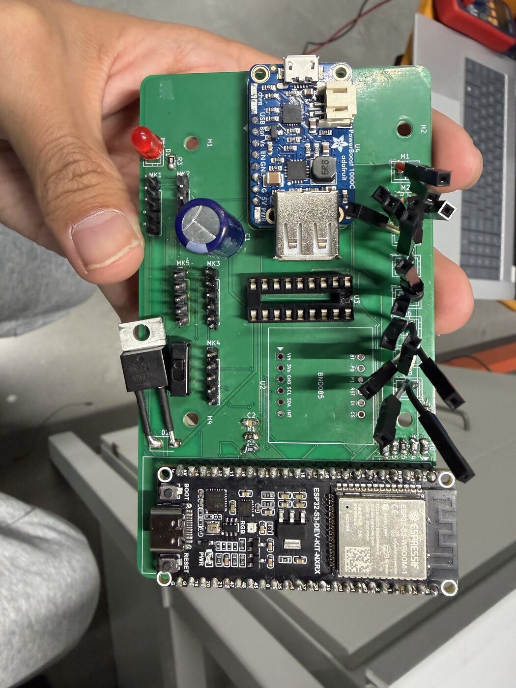 The populated carrier board, and first power-up with mic and motor leads attached